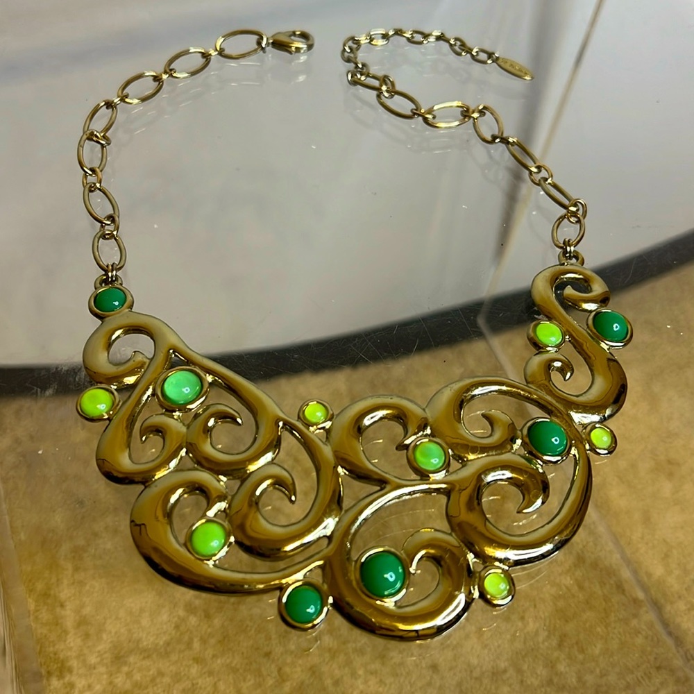 St. Thomas necklace with gold and green details.